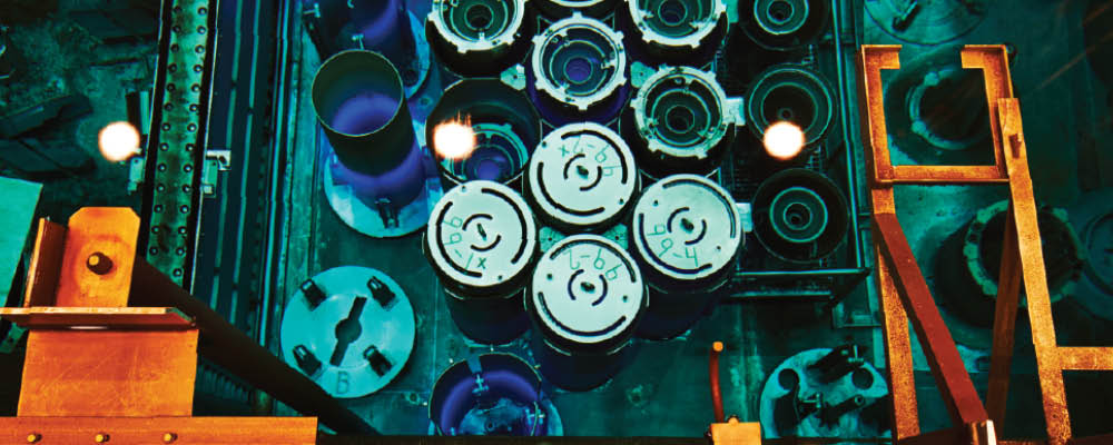 hfir-reactor-pool-thumb.jpg A blue glow from Cherenkov radiation in the reactor pool of the High Flux Isotope Reactor from stored fuel elements.